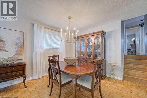 Parquet wood-finish flooring with light-toned walls and wood paneling - 3158 Palmer Drive, Burlington, ON 