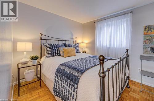 Parquet wood-finish flooring, neutral wall tones, and window with sheer drapery - 3158 Palmer Drive, Burlington, ON 