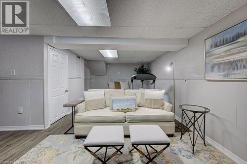 Recessed lighting, wood-finish flooring, paneled walls, and a dropped ceiling with integrated lighting - 3158 Palmer Drive, Burlington, ON 