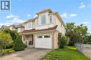 Two-story property with light-colored siding and brick accents, featuring a prominent bay window - 67 Apple Tree Drive, Kitchener, ON 