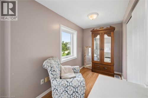 Wood-finish flooring, neutral wall tones, and a window with natural light - 67 Apple Tree Drive, Kitchener, ON 