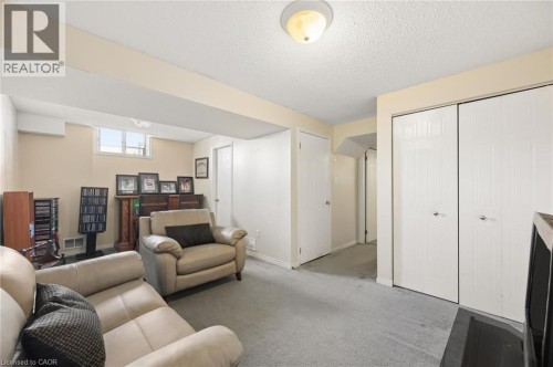 Recessed lighting, light gray carpeting, and window providing natural light - 67 Apple Tree Drive, Kitchener, ON 