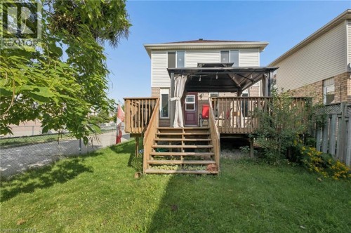 Expansive backyard featuring a wood deck with stairs, a gazebo, and a chain link fence - 67 Apple Tree Drive, Kitchener, ON 