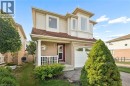 Brick and siding exterior with a covered porch, white column, and an attached garage with a white door - 67 Apple Tree Drive, Kitchener, ON 