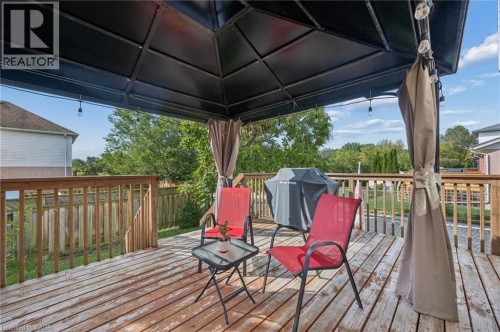 Expansive wood deck with a built-in gazebo featuring a dark canopy - 67 Apple Tree Drive, Kitchener, ON 