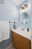 Wood-finish vanity with dual-door cabinetry, complete with an inset sink and light-toned countertop - 