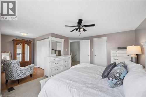 Ceiling fan with integrated lighting, two white panel doors, and neutral wall paint - 67 Apple Tree Drive, Kitchener, ON 