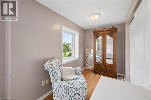 Wood-finish flooring, neutral wall tones, and a window with natural light - 67 Apple Tree Drive, Kitchener, ON 