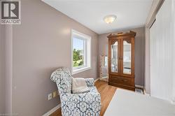 Wood-finish flooring, neutral wall tones, and a window with natural light - 