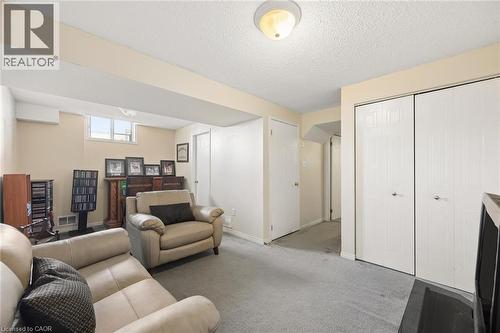 Recessed lighting, light gray carpeting, and window providing natural light - 67 Apple Tree Drive, Kitchener, ON 
