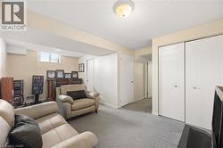Recessed lighting, light gray carpeting, and window providing natural light - 