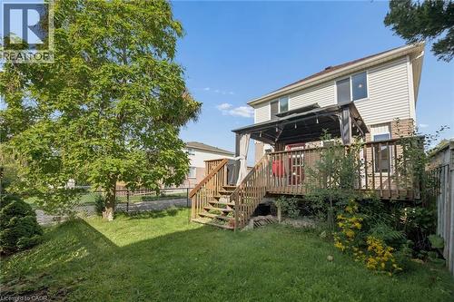 Elevated wood-finish deck with pergola, wood-finish stairs, and a level lawn area - 67 Apple Tree Drive, Kitchener, ON 
