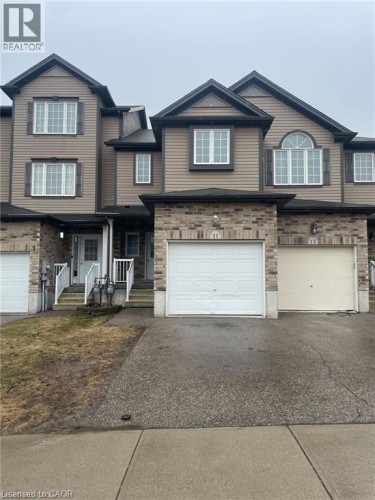 Two-story townhouse with a mixed-material facade, featuring brick and horizontal siding - 11 Sorrento Street, Kitchener, ON 