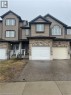 Two-story townhouse with a mixed-material facade, featuring brick and horizontal siding - 11 Sorrento Street, Kitchener, ON 