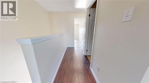 Wood-finish flooring with light-toned wall paint throughout - 11 Sorrento Street, Kitchener, ON 