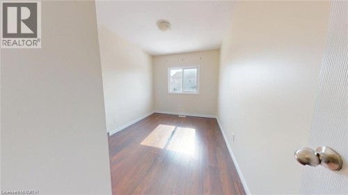 Wood-finish flooring, white walls, and a single window - 11 Sorrento Street, Kitchener, ON 