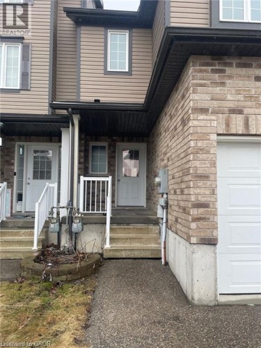 Brick and siding exterior featuring a single-car garage and concrete steps - 11 Sorrento Street, Kitchener, ON 