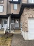 Brick and siding exterior featuring a single-car garage and concrete steps - 11 Sorrento Street, Kitchener, ON 