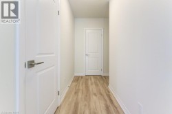 Bright white walls complement the wood-finish flooring in this hallway - 