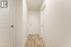 Neutral wall color throughout, featuring wood-finish flooring - 