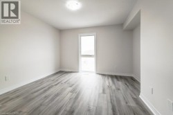 Recessed lighting, wood-finish flooring, white trim, and a window with natural illumination - 