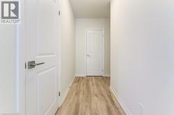 Bright white walls complement the wood-finish flooring in this hallway - 