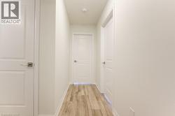 Neutral wall color throughout, featuring wood-finish flooring - 