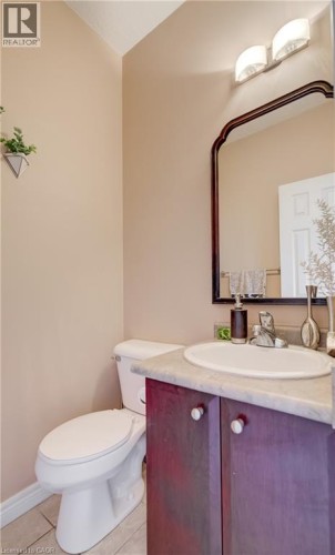 Built-in vanity with a circular basin sink and a wood-finish cabinet - 573 Robert Ferrie Drive, Kitchener, ON 