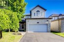 Two-story residence featuring light gray siding and stone cladding - 573 Robert Ferrie Drive, Kitchener, ON 