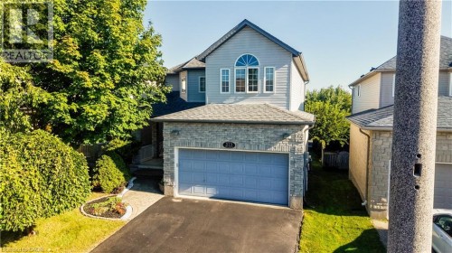 Stone veneer and siding exterior with an integrated garage - 573 Robert Ferrie Drive, Kitchener, ON 