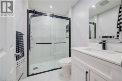 White vanity with integrated sink, black-finish faucet, and coordinating cabinet hardware - 
