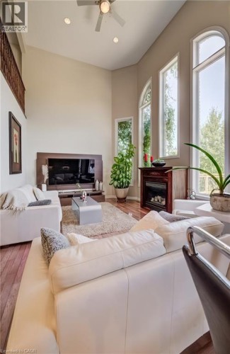Vaulted ceiling with a ceiling fan, recessed lighting, wood-finish flooring, and arched windows - 573 Robert Ferrie Drive, Kitchener, ON 