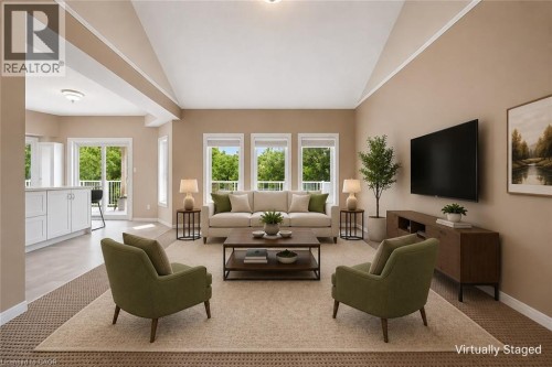 Vaulted ceilings, a series of three large windows, a sliding glass door with balcony access, and a kitchen island with white cabinetry - 426 Hidden Creek Drive, Kitchener, ON 
