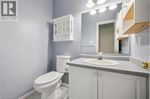 Vanity with an integrated sink, built-in cabinetry, and a mirror - 426 Hidden Creek Drive, Kitchener, ON 