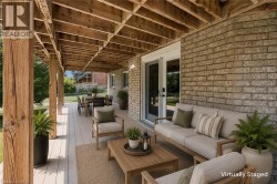 Covered outdoor patio with exposed wood beam ceiling - 