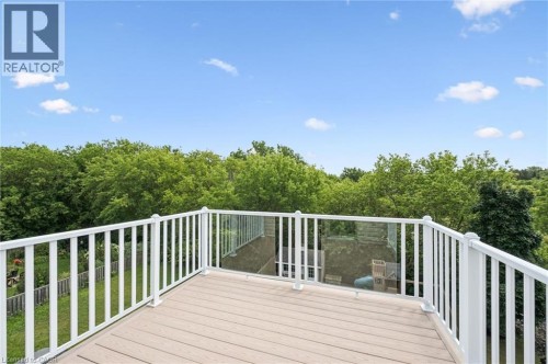 Exterior deck with composite flooring, white railing, and glass paneling - 426 Hidden Creek Drive, Kitchener, ON 
