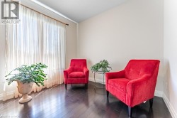 Expansive window with sheer drapes, dark wood-finish flooring, and light-toned walls - 