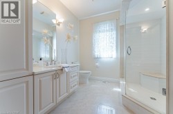 White vanity with integrated sink, polished chrome faucet, and mirrored wall - 