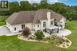 Expansive exterior with a stucco finish, multi-level patio, and a covered outdoor living area - 