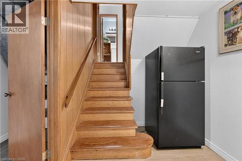 Wood-paneled staircase with a wooden handrail, leading to an upper level - 114 Shuh Avenue, Kitchener, ON 