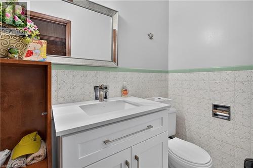 White vanity with integrated sink, chrome faucet, and white countertop - 114 Shuh Avenue, Kitchener, ON 