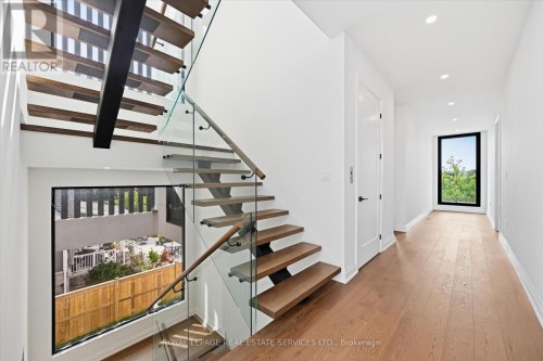 An Open-Riser Staircase with Glass Panels - 36 Windemere Road, Hamilton, ON 