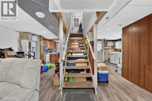 Wood-finish flooring throughout, with a wood panel accent wall - 121 Panin Road, Burlington, ON 