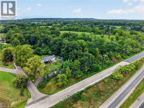 Single-story residence with a white exterior, set within a verdant landscape - 121 Panin Road, Burlington, ON 