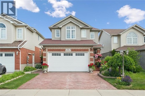 Two-story residence featuring light-colored siding and brick accents - 86 Bridlewreath Street, Kitchener, ON 