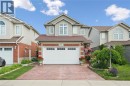 Two-story residence featuring light-colored siding and brick accents - 86 Bridlewreath Street, Kitchener, ON 