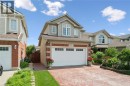 Brick and siding exterior with a two-car garage - 86 Bridlewreath Street, Kitchener, ON 