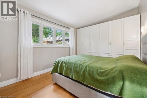 Hardwood flooring, multi-pane windows, built-in white cabinetry, and wall-mounted sconce lighting - 100 Forest Hill Drive, Kitchener, ON 