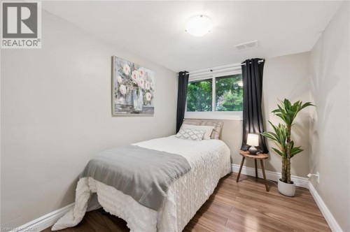 Recessed window with dark panel curtains, hard-surface flooring, and a flush-mount ceiling light fixture - 100 Forest Hill Drive, Kitchener, ON 