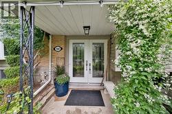 Exterior featuring a patterned paver driveway, an integrated garage, and stone accents - 